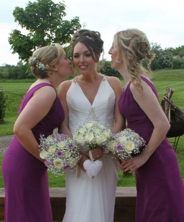 brides bouquet and bridesmaids in lilac roses with ivory roses and gypsophila hand tied wedding bouquet