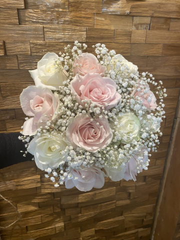 Neat hand tied bridal bouquet of pink & ivory roses with Gyp