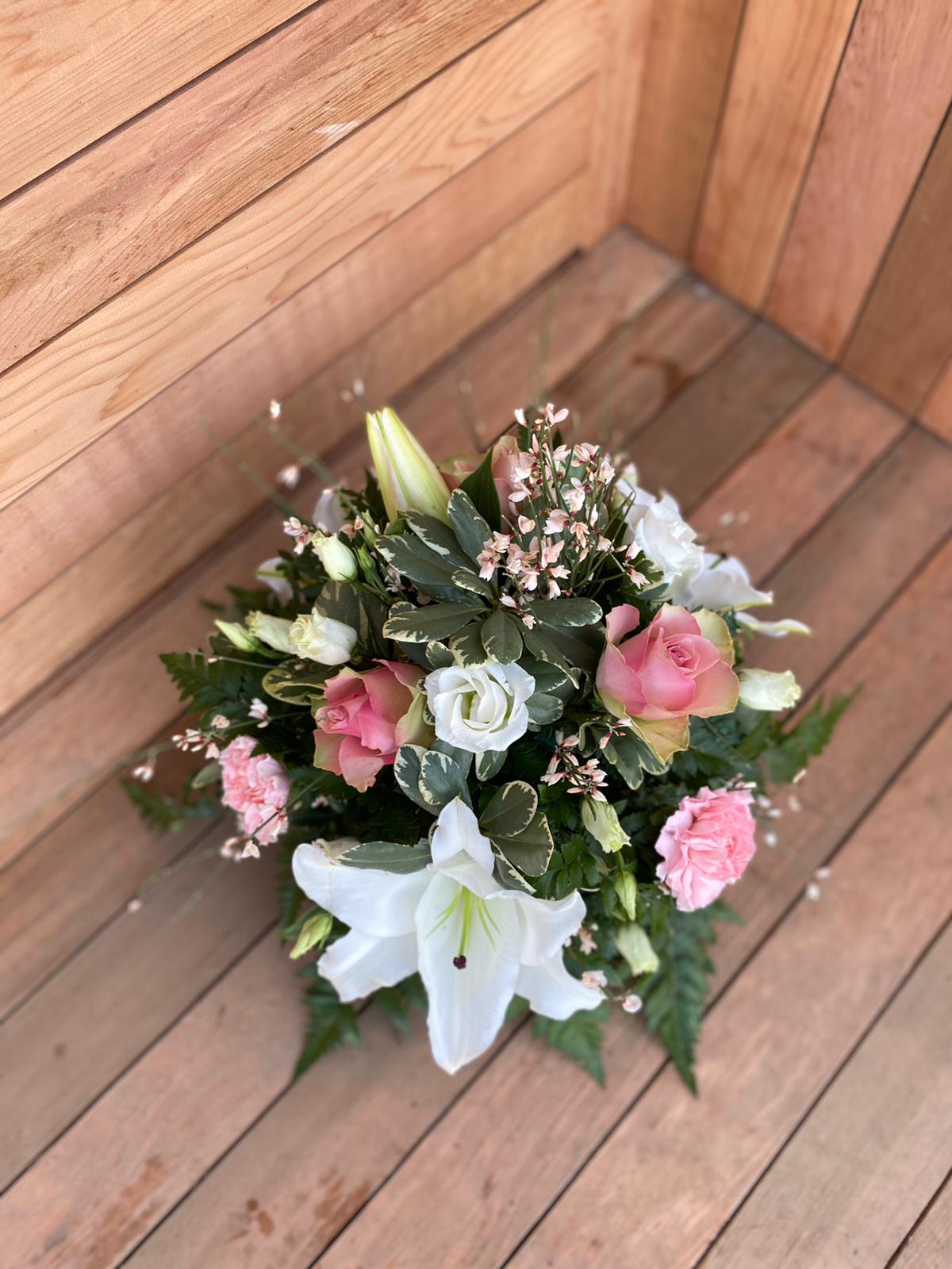 A tranquil and peaceful posy tribute. A selection of pink and white pretty flowers and subtle foliage. Available in other colours. Same day delivery. Due to seasonal variations some items may be substituted to produce a display of equal quality and value. Professionally arranged by our expert florists with care. Delivered by hand by our own driver. Click & collect is also available