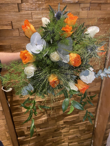 wild looking orange & ivory roses with mixture of foliage's