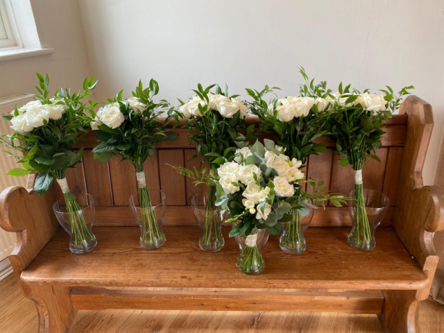 Bridal & bridesmaids bouquets of ivory roses & soft ruscuss