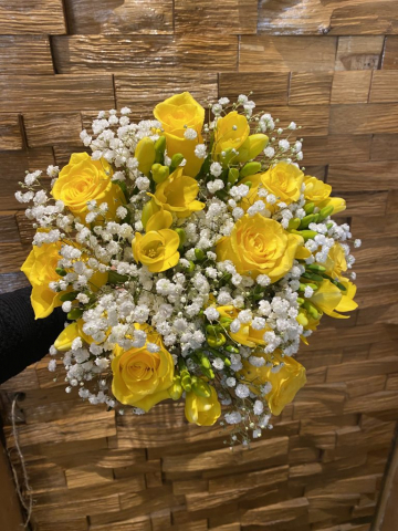 Neat bridal bouquet with yellow roses freesia & gyp