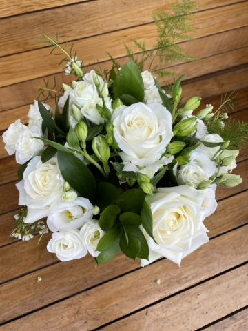 classic hand tied of ivory roses lissianthus and alstro hand tied with foliage bridal bouquet