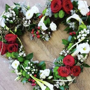 A bespoke design in a open heart red roses and callas can be in any colours of your choice. Same day delivery. Due to seasonal variations some items may be substituted to produce a display of equal quality and value.