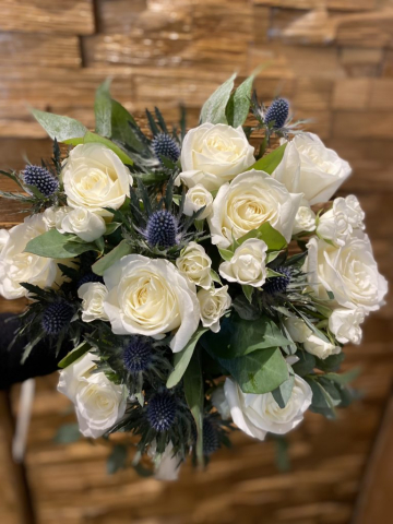natural rustic wedding flowers foliage ivory rose blue thistle and green soft ruscuss eucalyptus hand tied bouquet