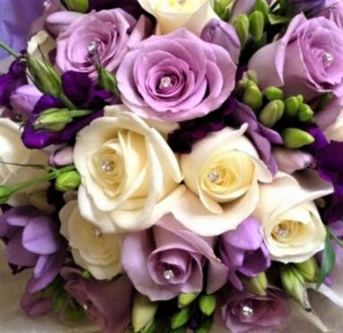 lilac roses with ivory roses and purple lisianthus hand tied wedding bouquet