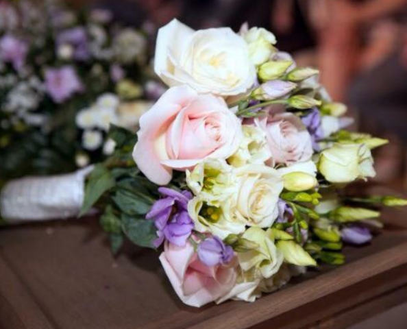 bridal bouquet hand tied roses with lilac lisianthus and freesia and foliages