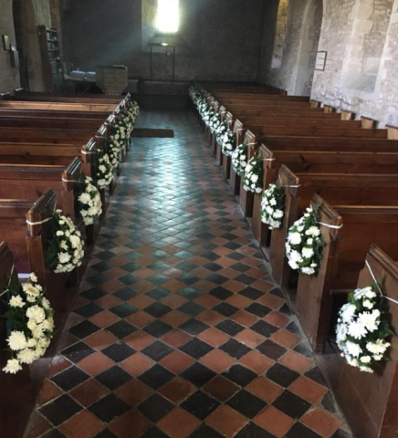 Church aisle pew ends white flowers