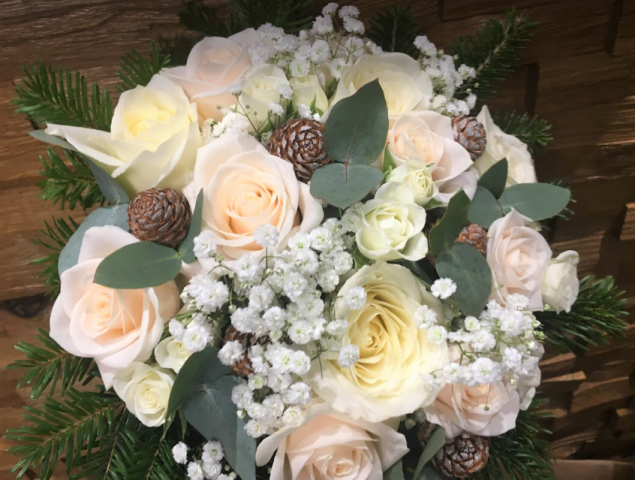bridal bouquet hand tied touches of gypsophila and roses with cones and foliages