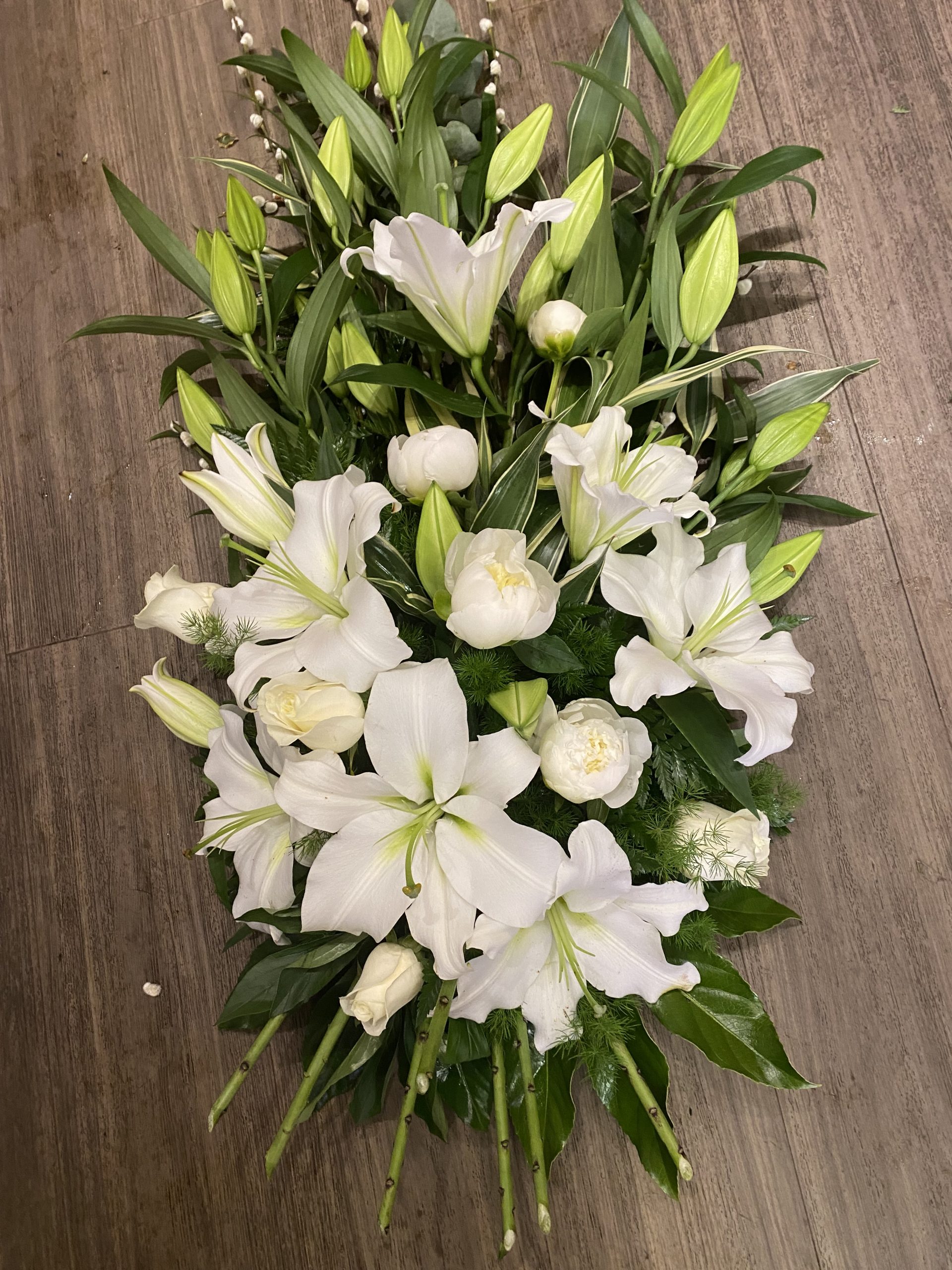 hand tied bio degradable sheaf white lilies and tied with natural raffia