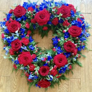 An stunning open heart tribute. Deep Red Roses with contrasting purple veronica  and subtle foliage. Available in any colour. 24 hours notice or similar design same day delivery. Due to seasonal variations some items may be substituted to produce a display of equal quality and value. We can offer delivery by our own drivers or click and collect is available. Professionally arranged by our expert florists with care. Delivered by hand by our own driver. Due to seasonal variations some items may be substituted to produce a display of equal quality & value.