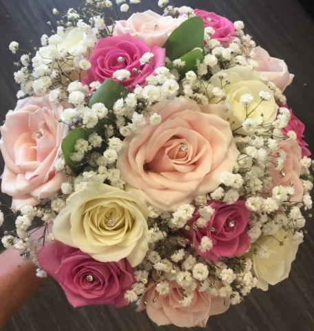 bridal bouquet of pastel pink dark pink roses and ivory roses gypsophila