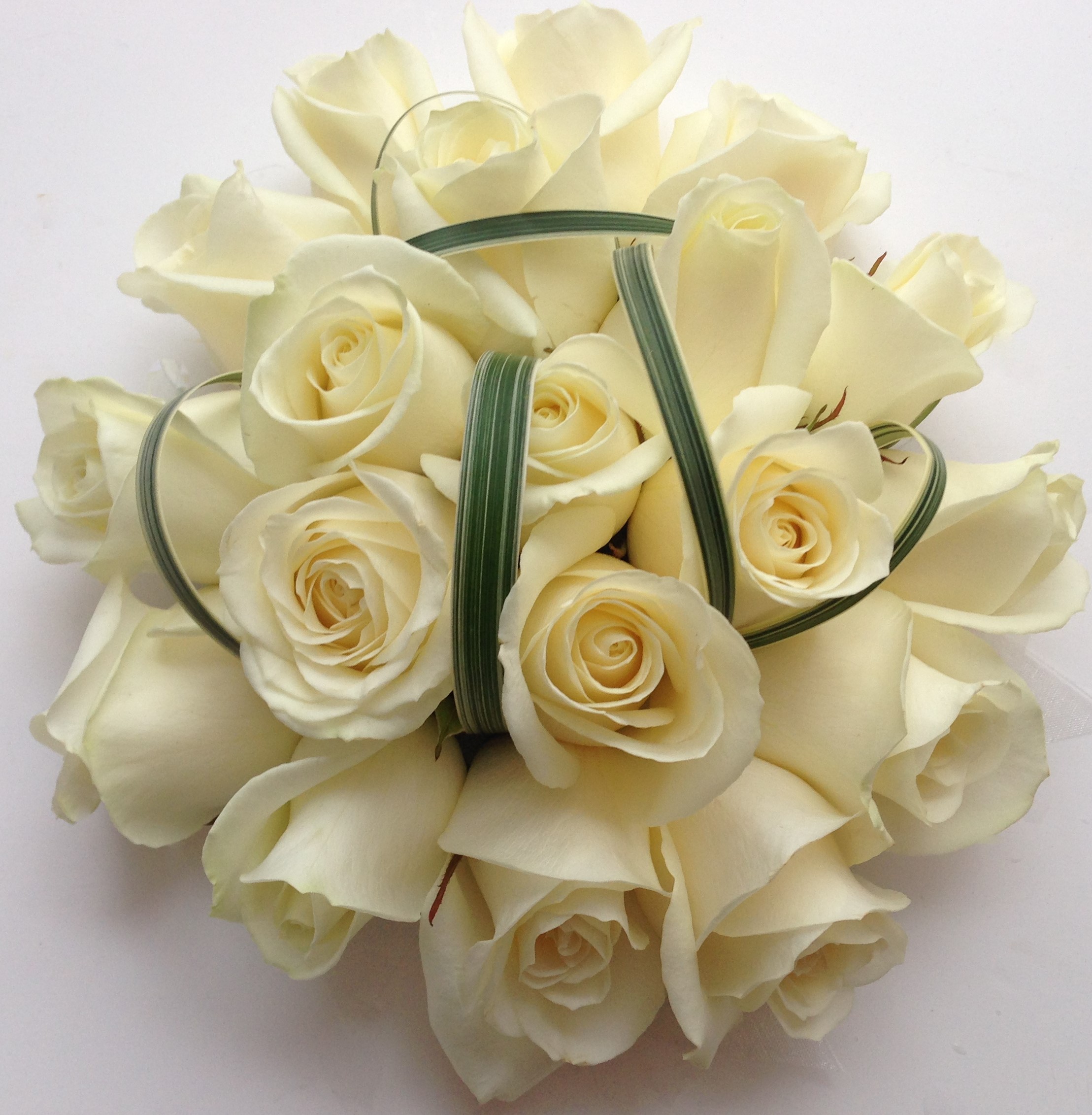 wedding flowers for bride in a hand tied style just roses china grass foliage