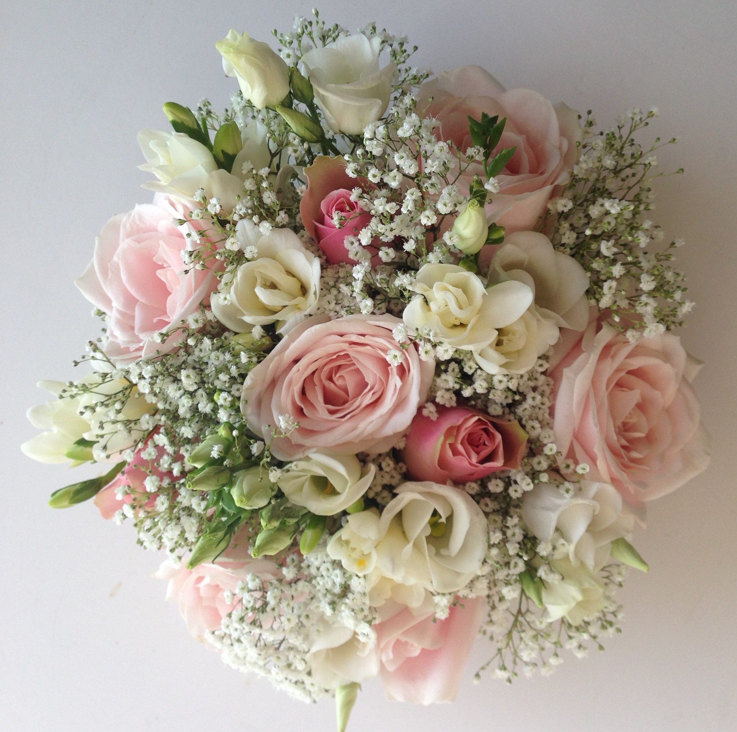 bridal bouquet of roses and ivory freesia  lisianthus gypsophila