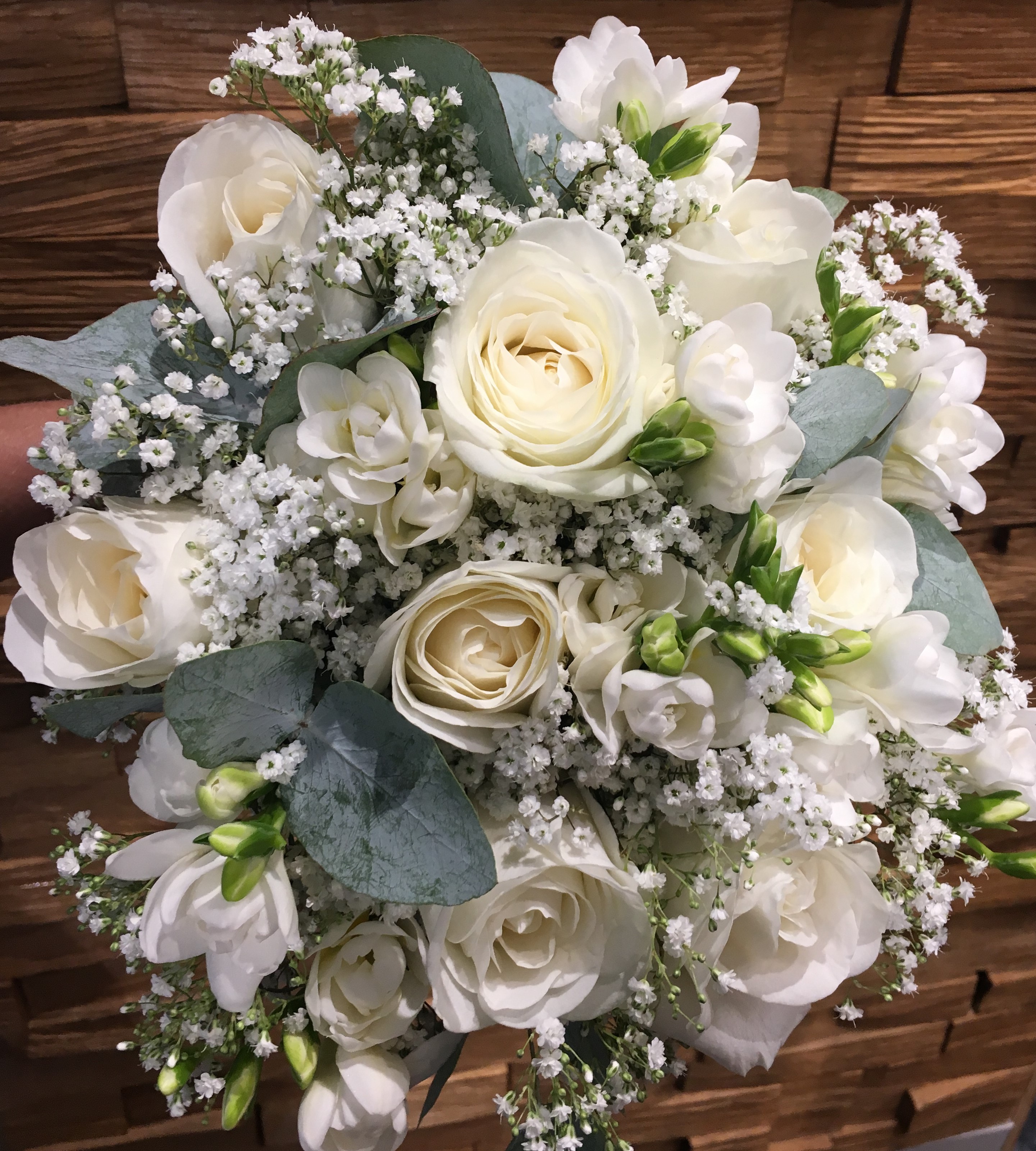 bridal bouquet of roses and ivory freesia  gypsophila eucalyptus