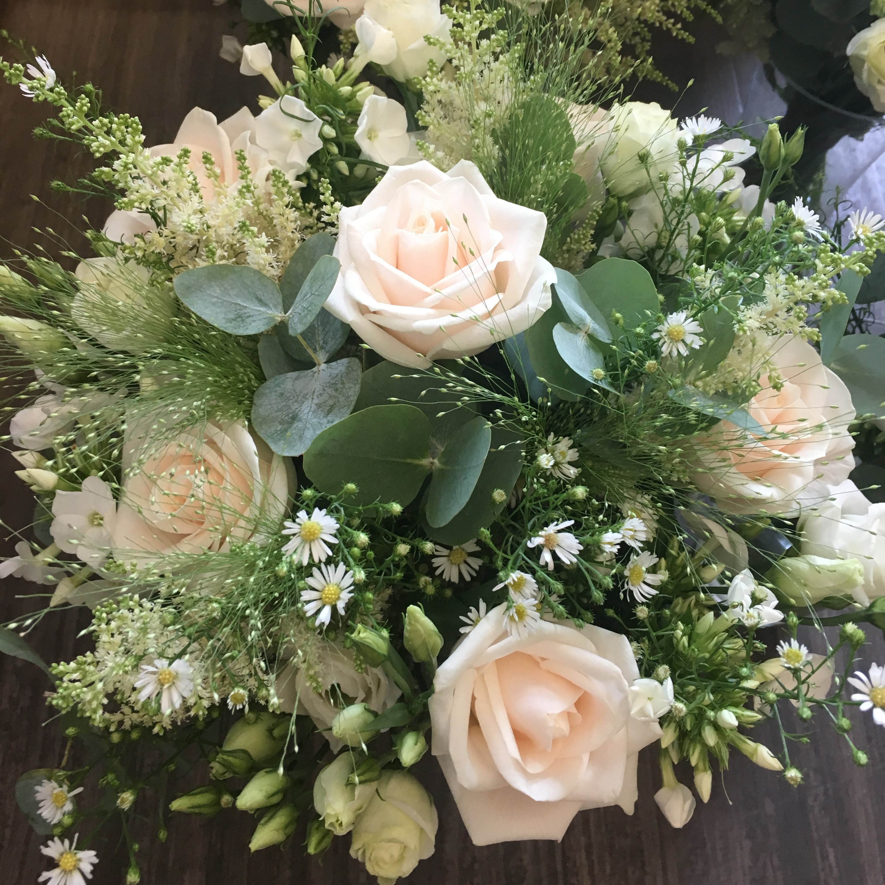 rustic wild theme wedding hand tied bouquet of roses and foliages