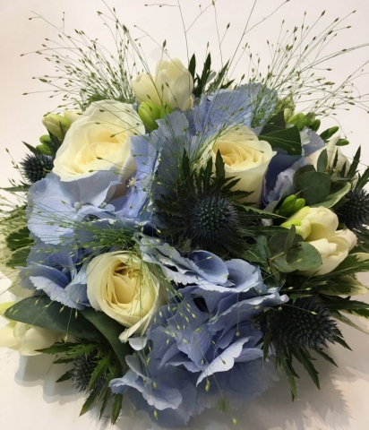 hand tied of roses thistle and lisianthus  freesia and hydrangea wild country style