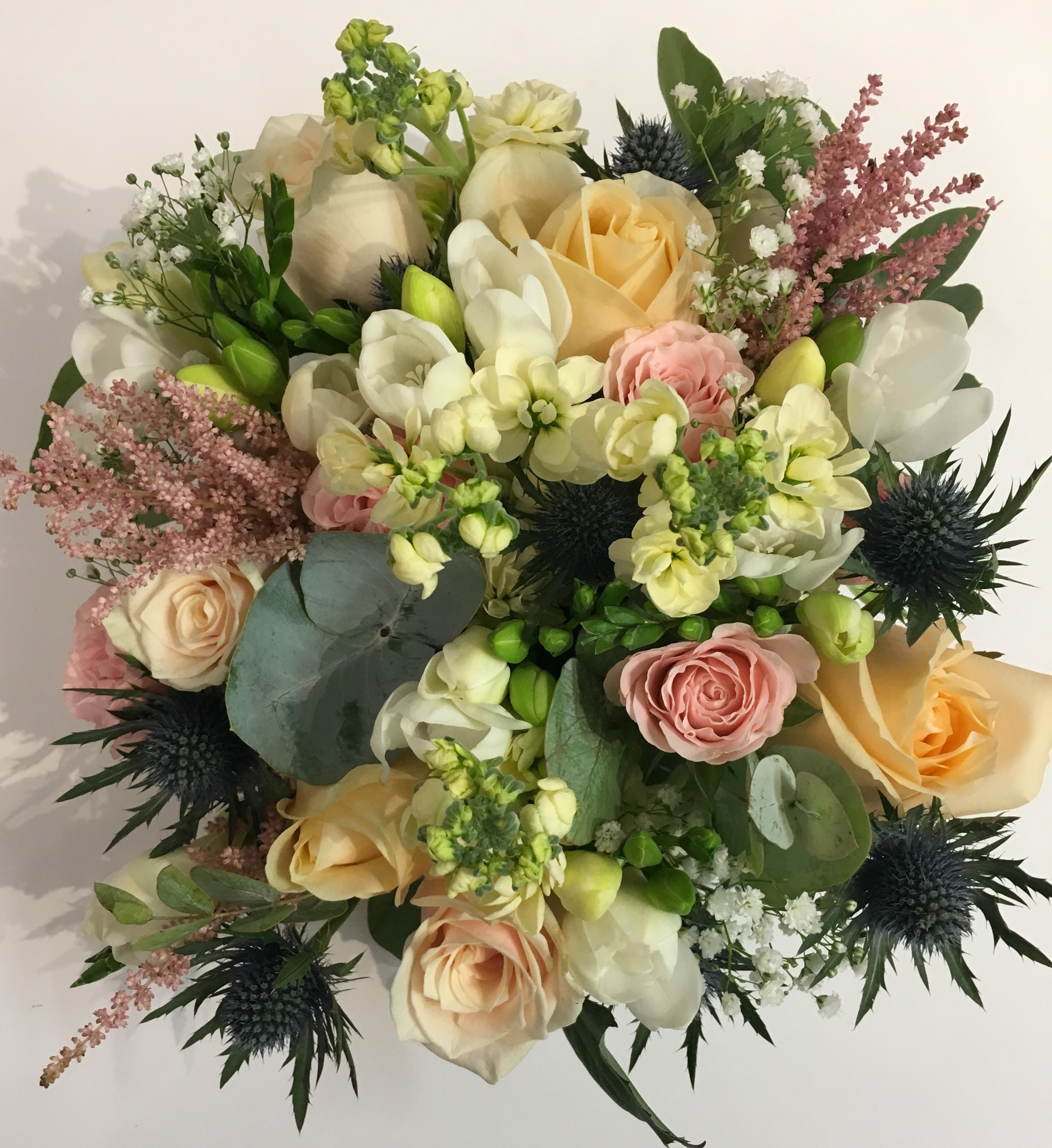 country style wedding flowers hand tied with peach roses and soft pinks
