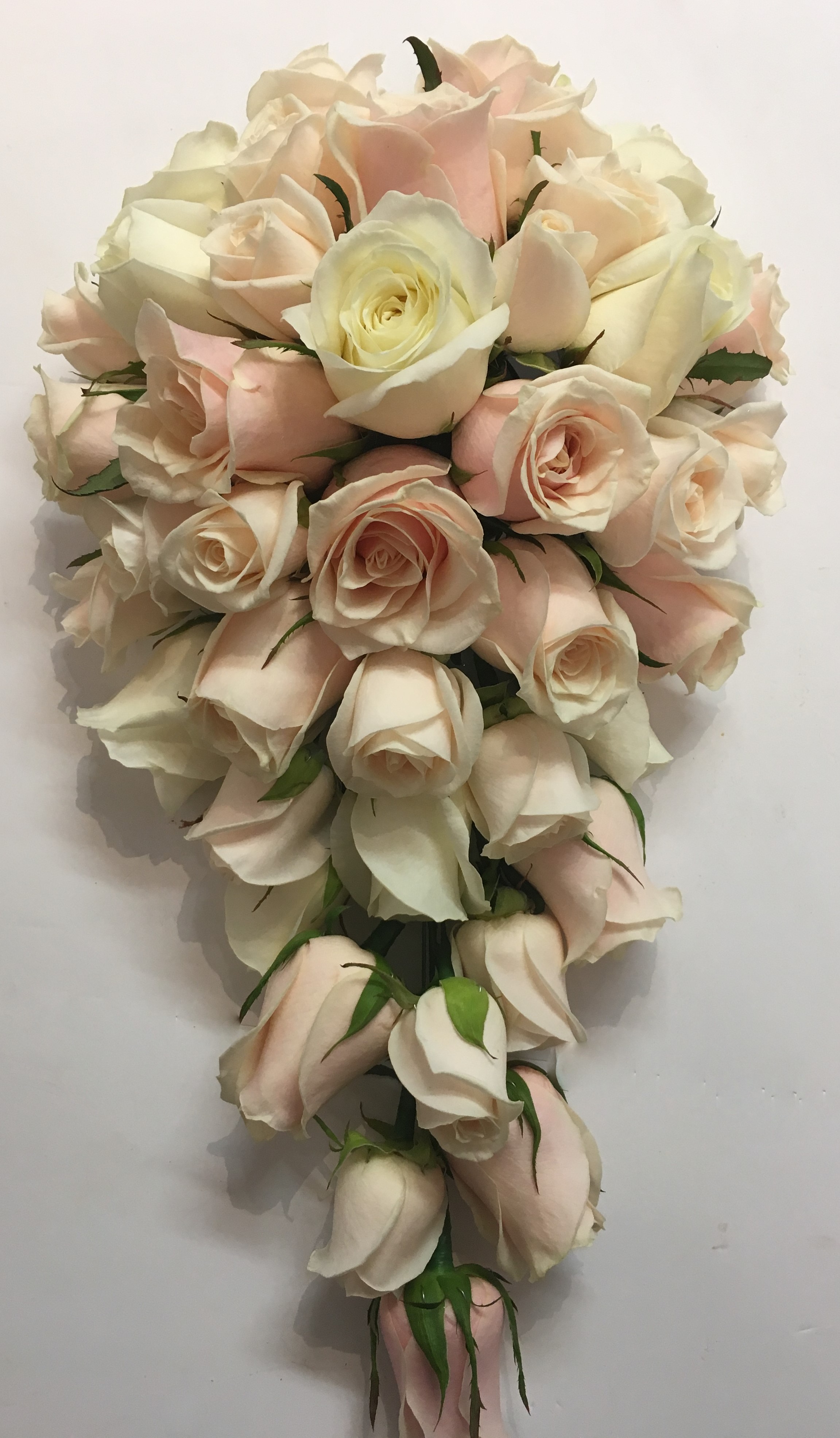 wedding flowers for bride in a hand tied style just pastel pink and ivory roses