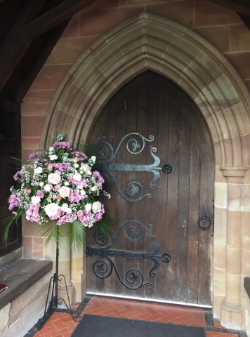 Pink & white pedestal arrangement church doorway