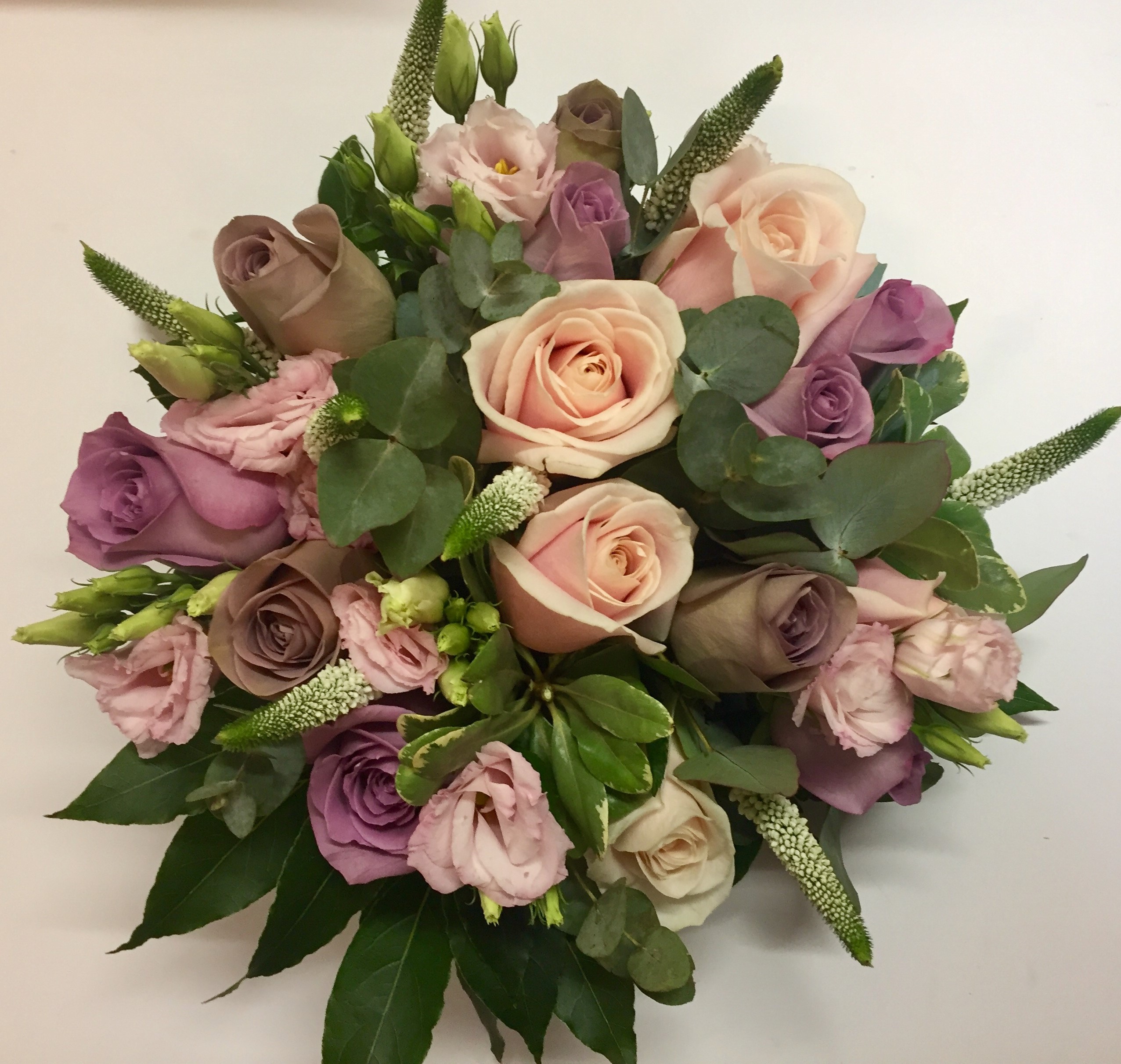 rustic wild theme wedding bouquet of roses lisianthus and freesia veronnica and wax flower and foliages