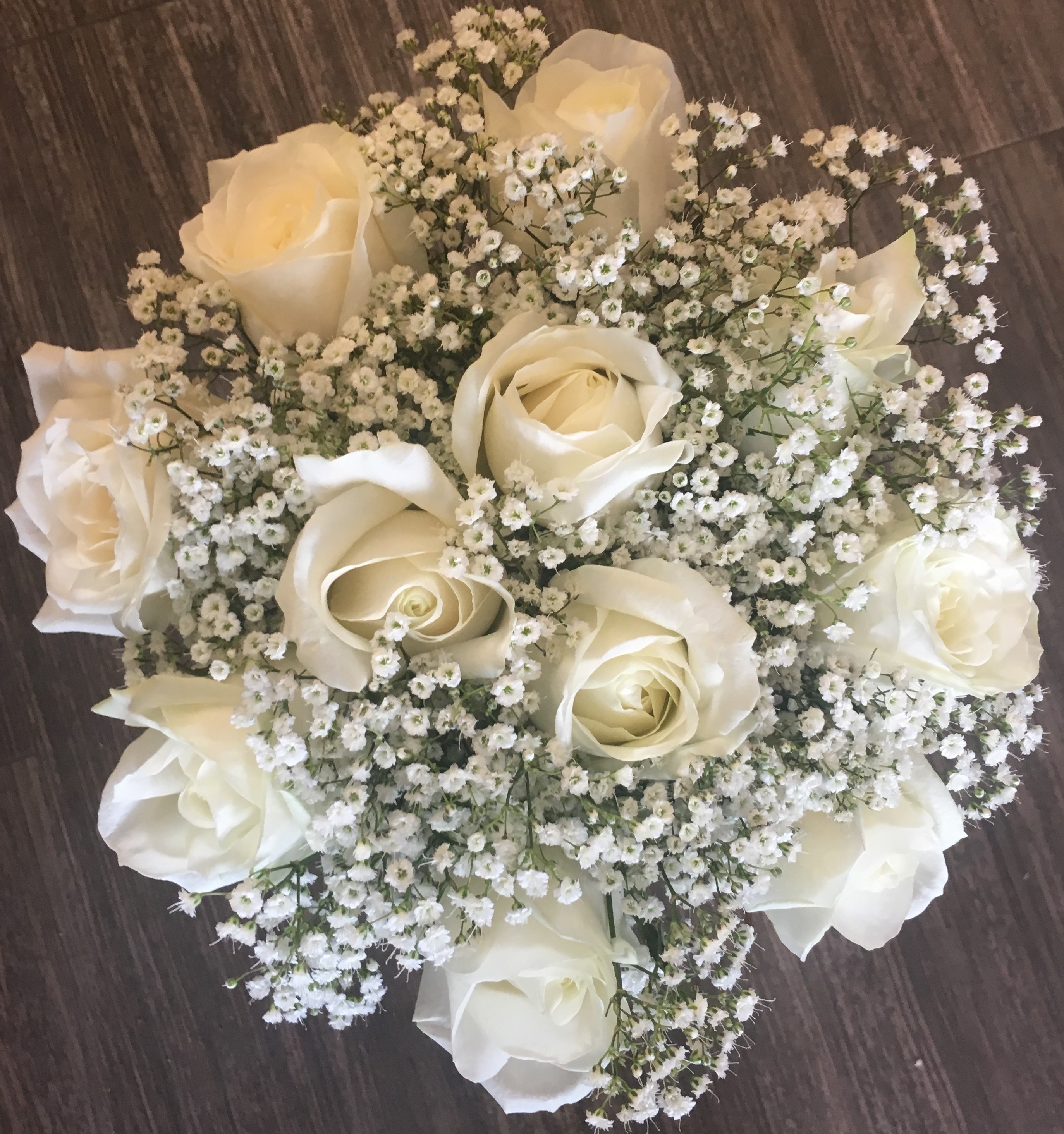 white roses hand tied with gypsophila in studley flair with flowers