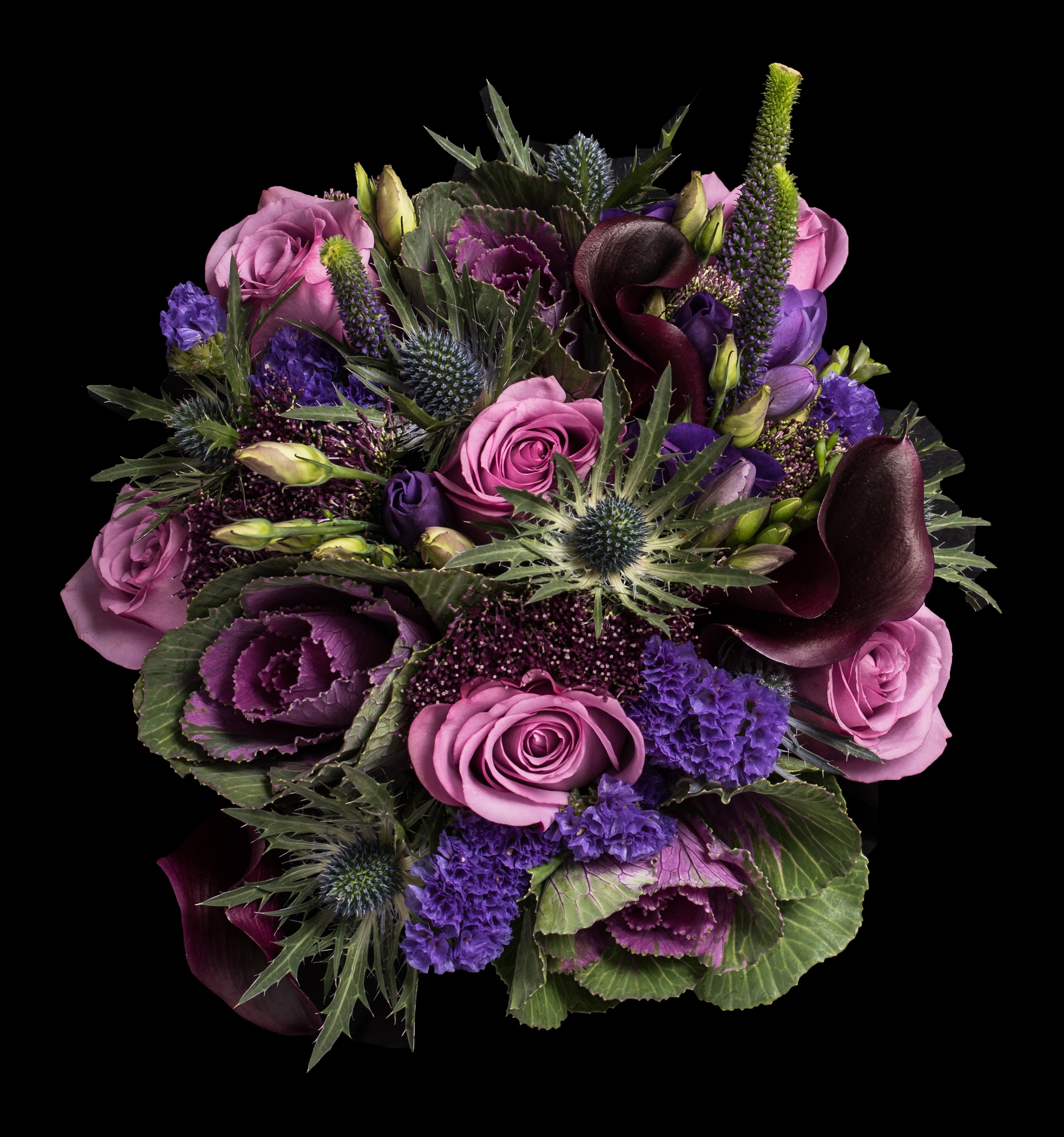 hand tied of roses thistle and lisianthus  freesia and veronica plum calla