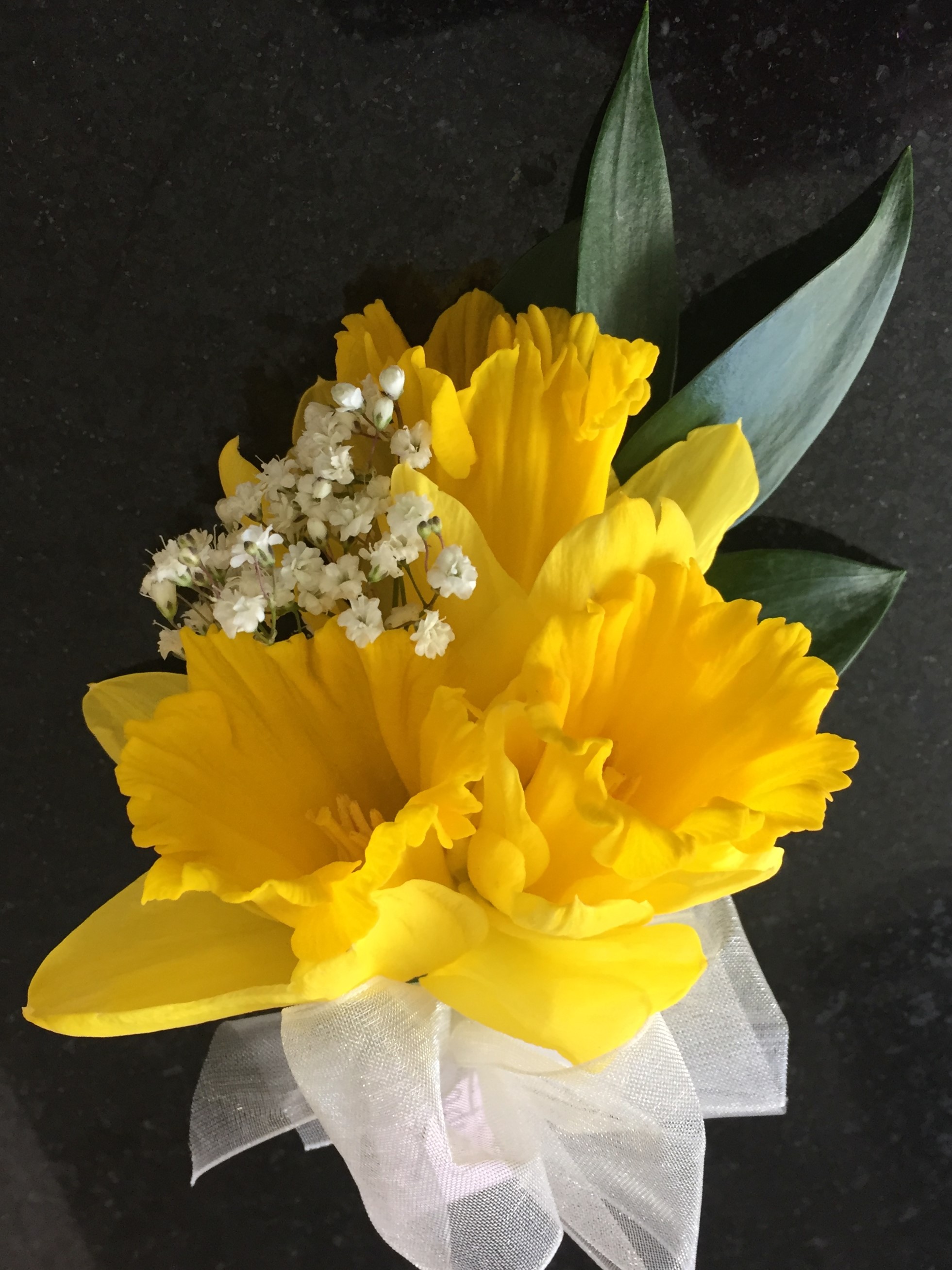 yellow daffodil ivory bow ladies buttonhole