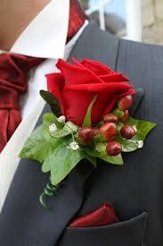 christmas buttonhole red rose hyperican berry grey suit flower