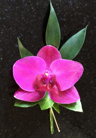 exotic flower in pink buttonhole
