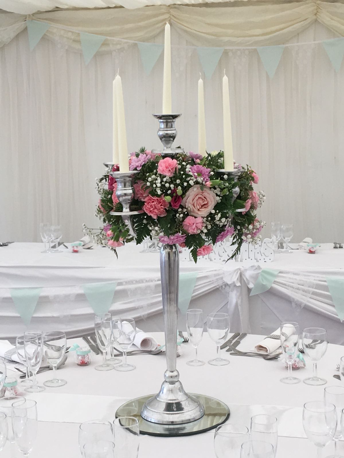 Pink carnations white flowers candelabra