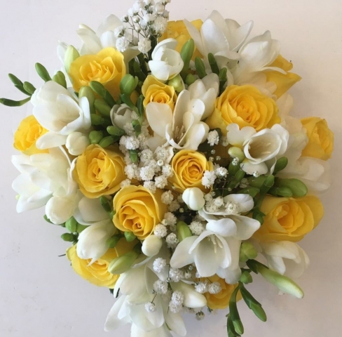 bridal bouquet hand tied touches of gypsophila and yellow roses with freesia
