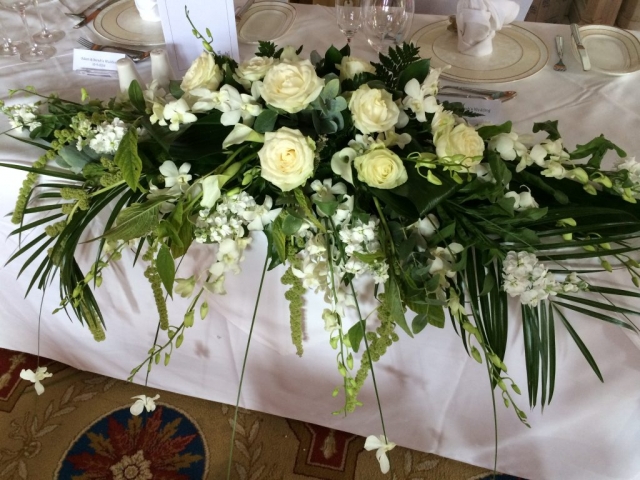 top table white flowers Top table arrangement with flowing orchids and roses at Studley Castle