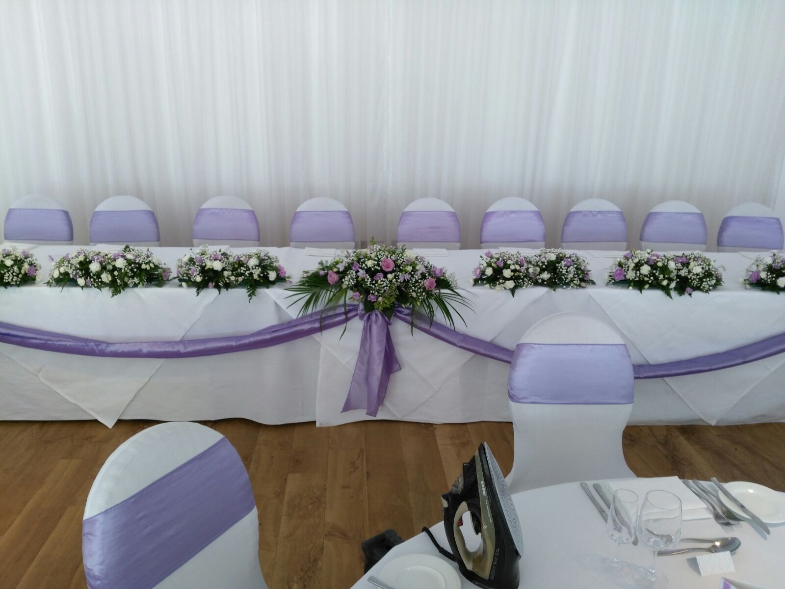 Top table with lilac swags and flowers