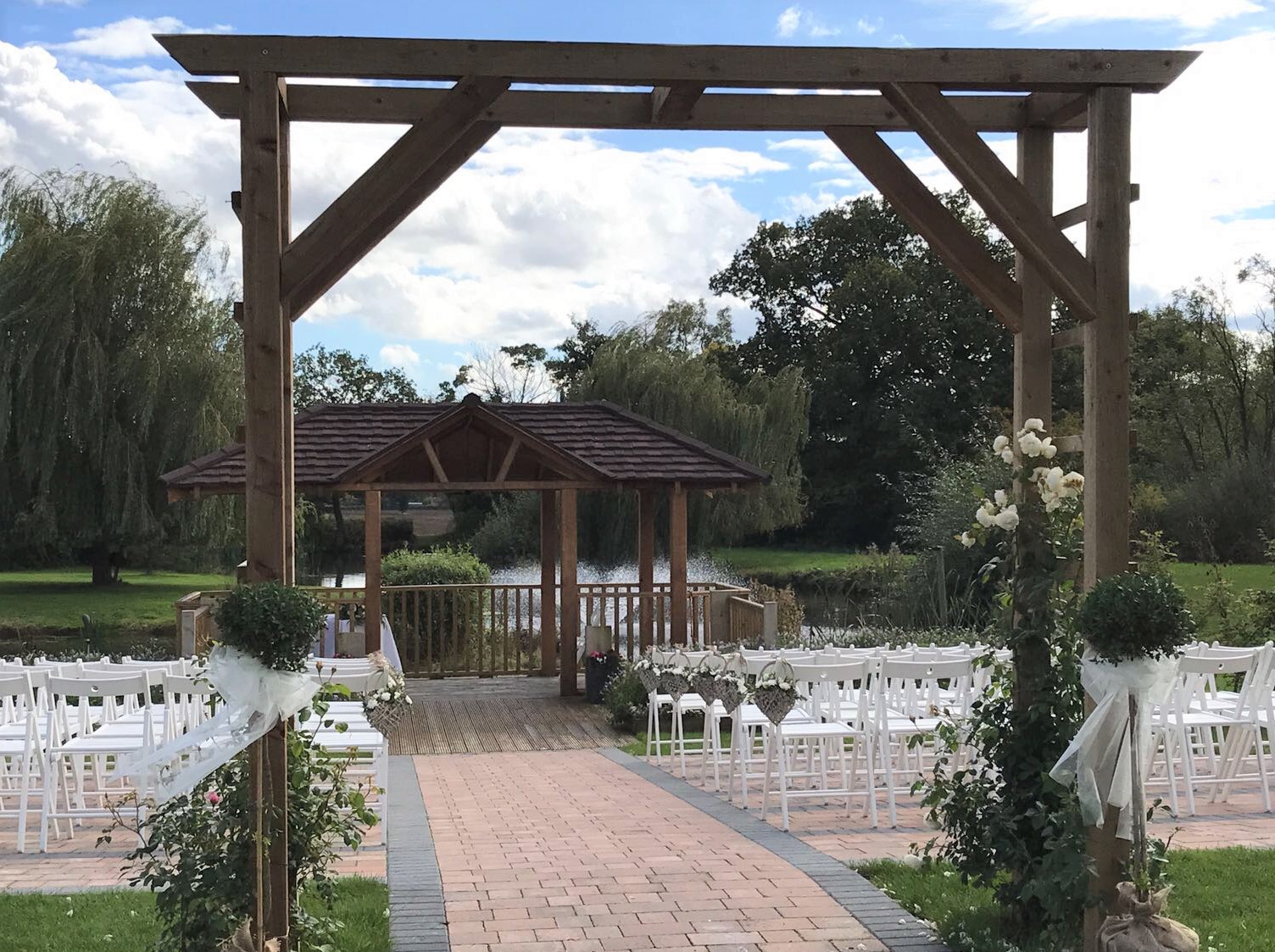 wootton park gyp wicker baskets down aisle Swags on arch rustic look aisle outside weddings Wootton  Park