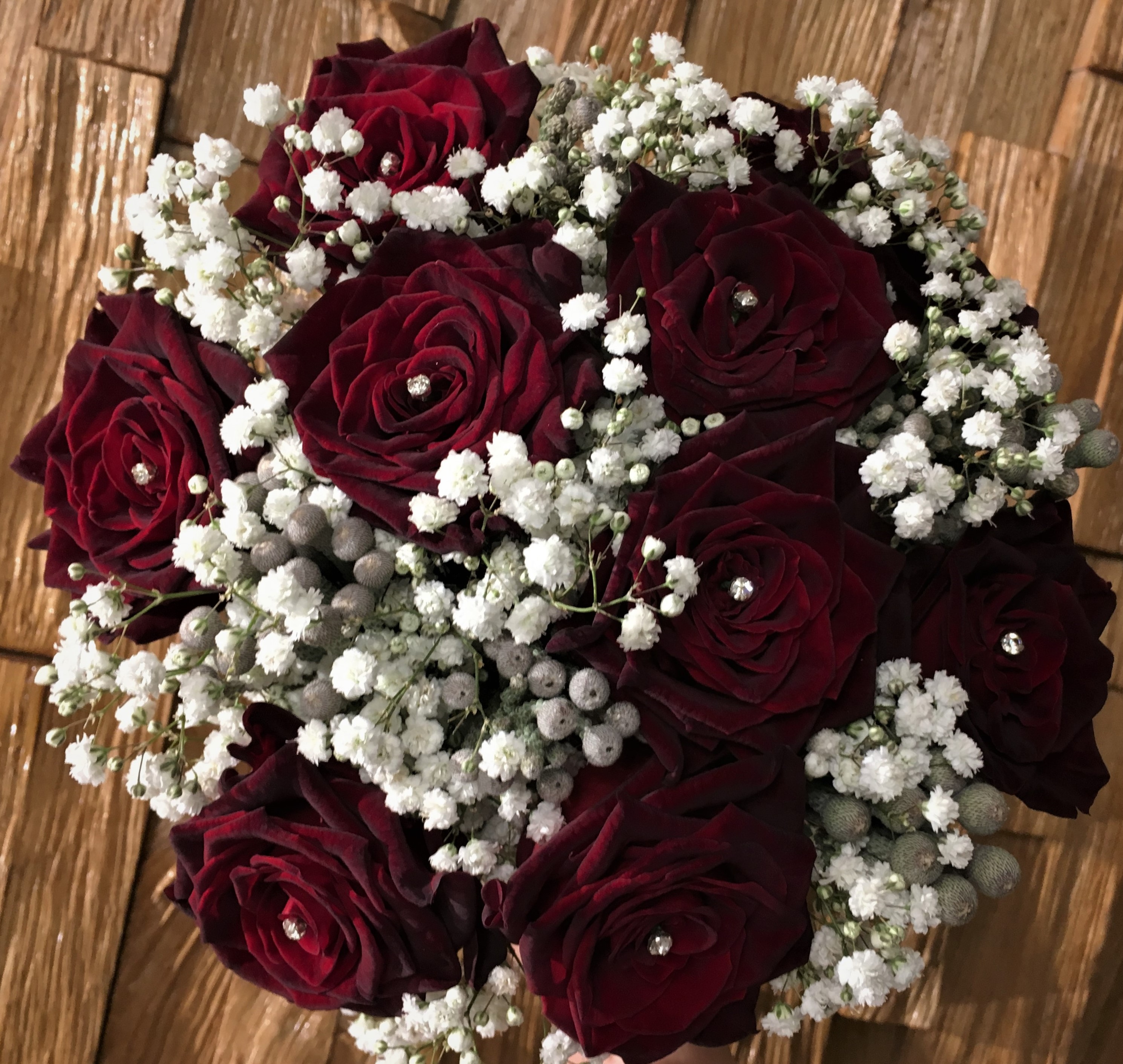 deep burgundy roses  flowers in bouquet hand tied bouquet