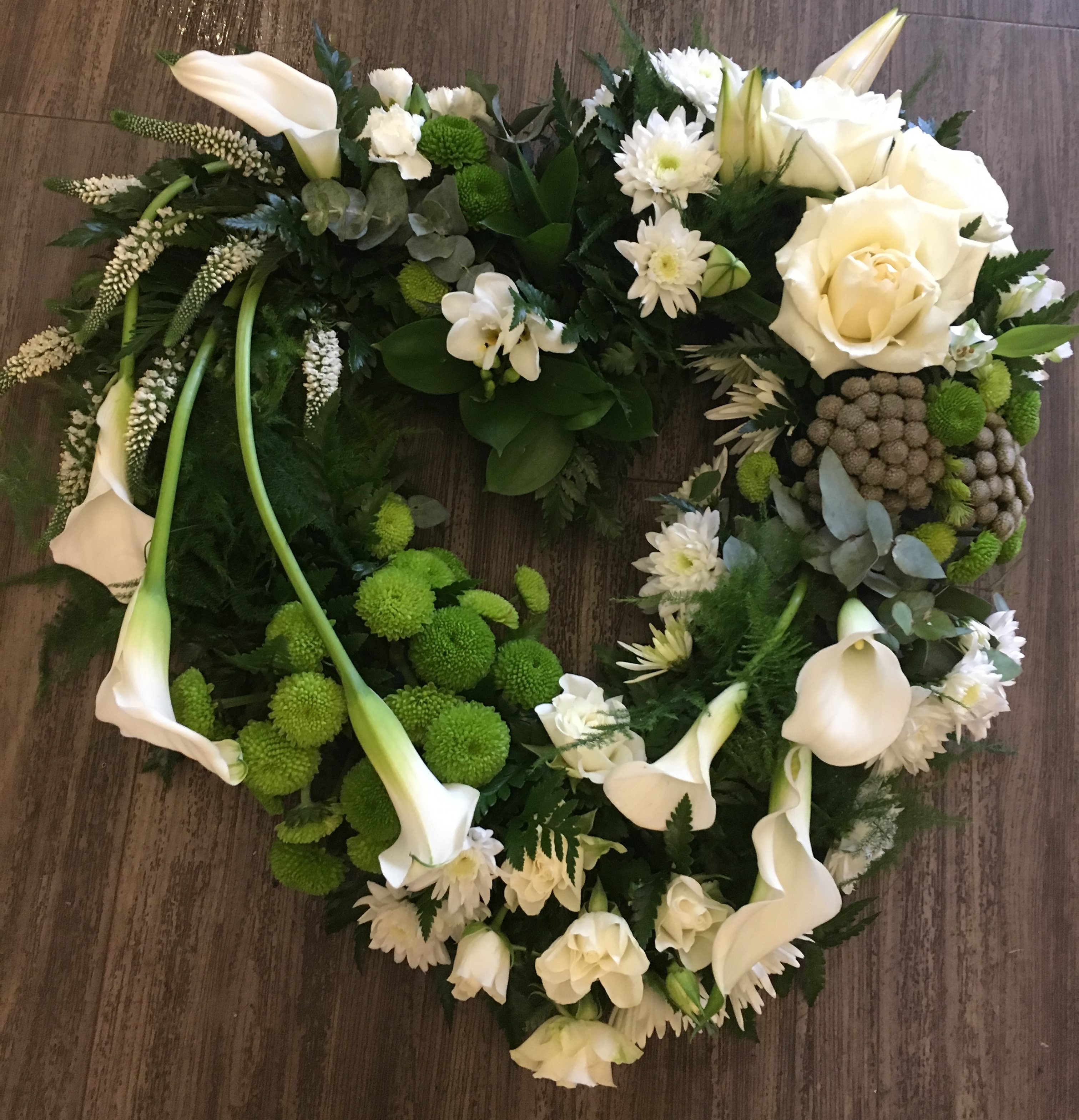 bespoke fresh flowers in a woodland rustic style heart clusters of fresh flowers tribute