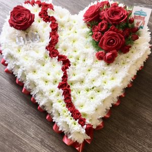 Broken Heart tribute. beautifully crafted arrangement symbolising the loss of your sole mate or loved one. This elegant display, shaped like a broken heart, features a delicate balance of red roses for love. A touching tribute to honour the life of a loved one who has passed.Handcrafted with care by our expert florists, this tribute is available for delivery to funeral homes or directly to the family, ensuring a meaningful and timely gesture in their time of need.