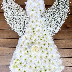 A lovely massed angel in white with touches of feathers and glitter on the flowers Colour of you choice 24hrs notice required Due to seasonal variations some items may be substituted to produce a display of equal quality and value. Professionally arranged by our expert florists with care. Delivered by hand by our own driver. Click & collect is also available