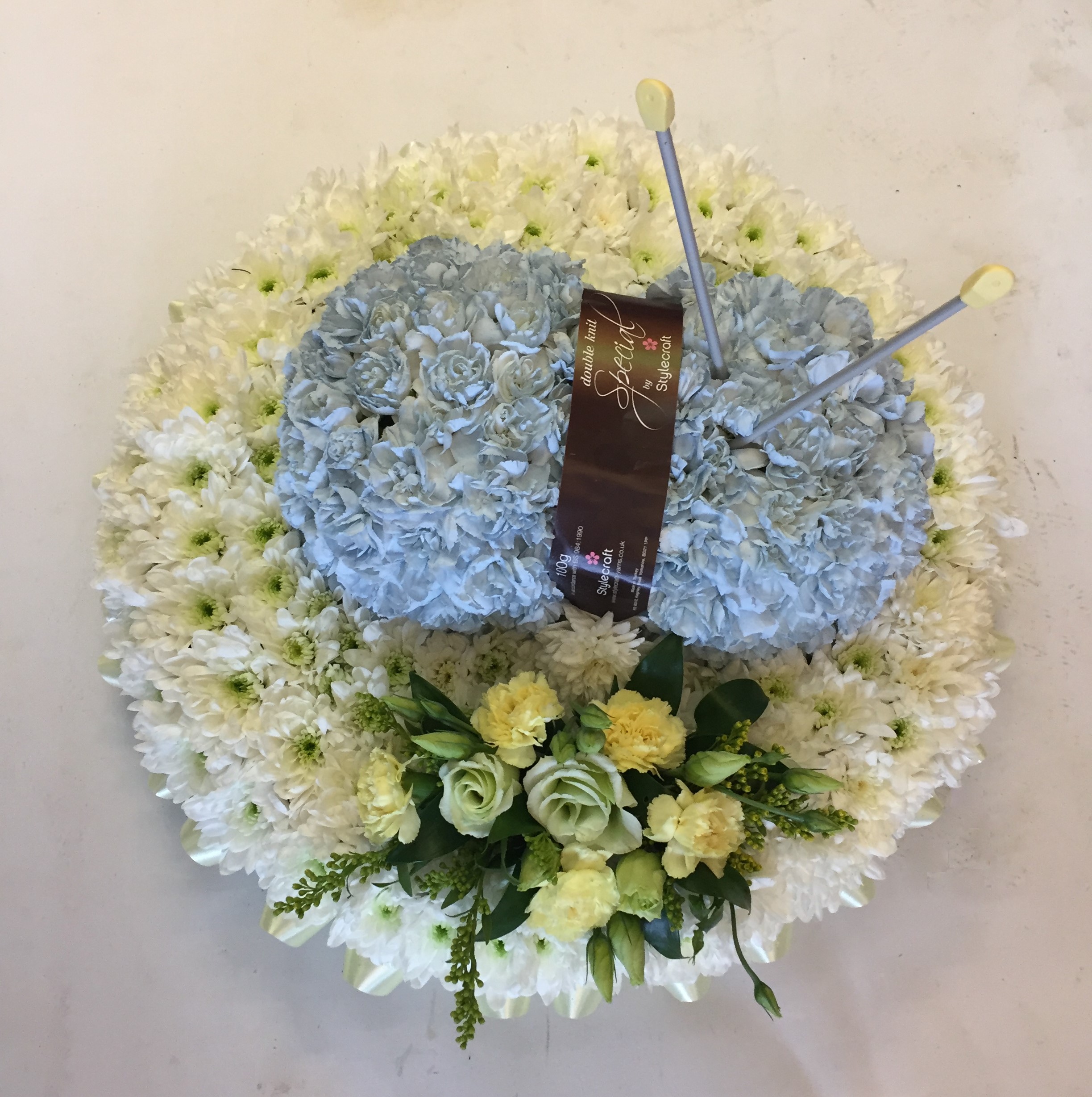 Bespoke Knitting Tribute in a Design of a Ball of Wool and Knitting Needles REDDITCH FLORIST, FUNERAL ITEM, PERSONAL FLOWERS.