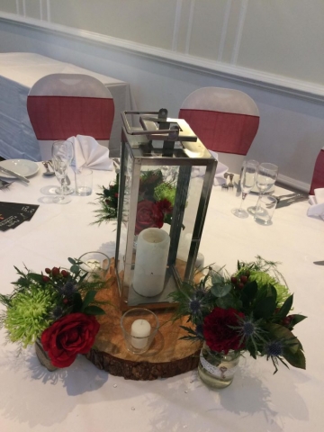 lantern and logs for hire with tea lights and jam jar flowers SOUTHCREST HOTEL