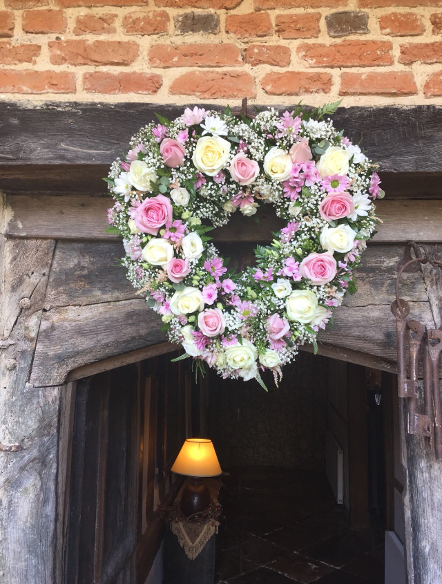 Heart of flowers over the entrance of Gorcott Hall