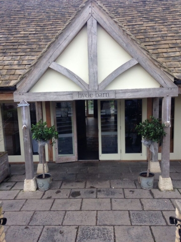 simple bay trees either side of the entrance door hyde barn