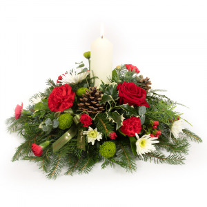 A Christmas candle arrangement, perfect for the festive table, handmade using favourite Christmas flowers and foliage