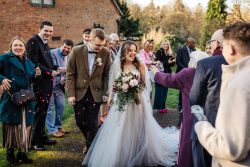 Bridal bouquet of baby pink sweet avalanche & burgundy flowers perfect for a winters wedding with trails of soft foilages